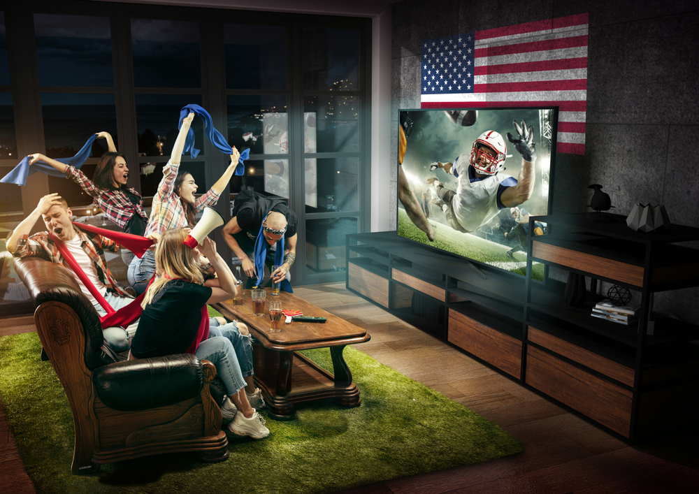 Group of friends watching TV, american football match, championship.